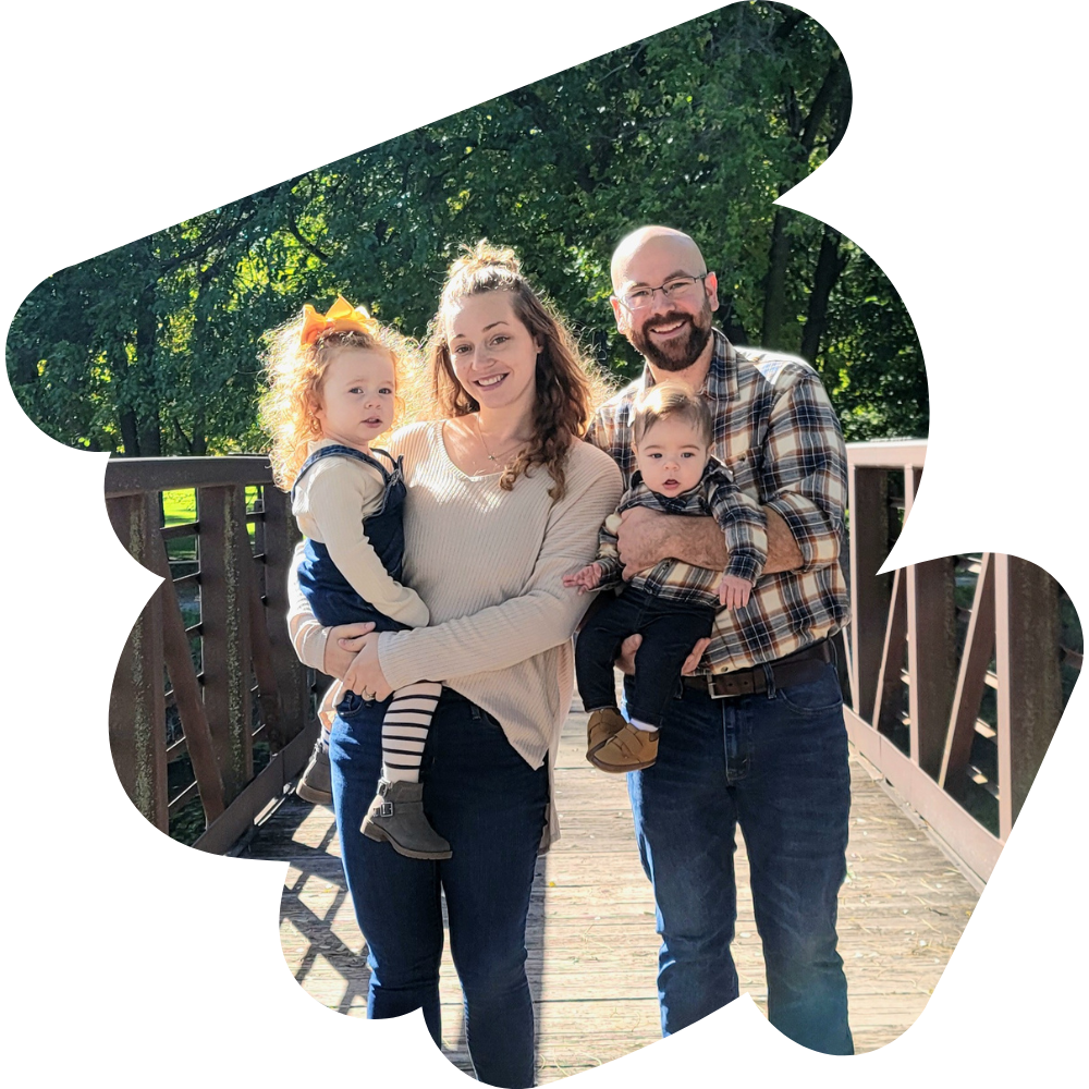 couple holding two children